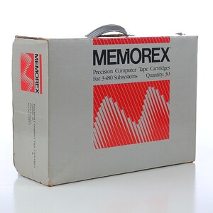 May include: A white box with a gray handle and the text "MEMOREX Precision Computer Tape Cartridges For 3480 Subsystems Quantity: 30" printed in black. The box has a red and white graphic design.