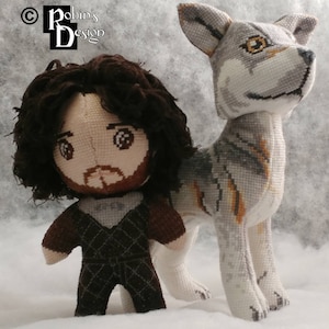 May include: A plush toy of Jon Snow from Game of Thrones, wearing a brown and black outfit, standing next to a grey and white plush direwolf.