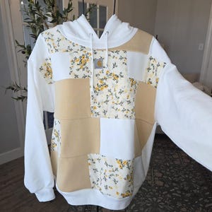 May include: A set of three ceramic mugs with a speckled, matte finish. Each mug features a different color: light blue, cream, and gray. The mugs have a simple, modern design and a comfortable handle.