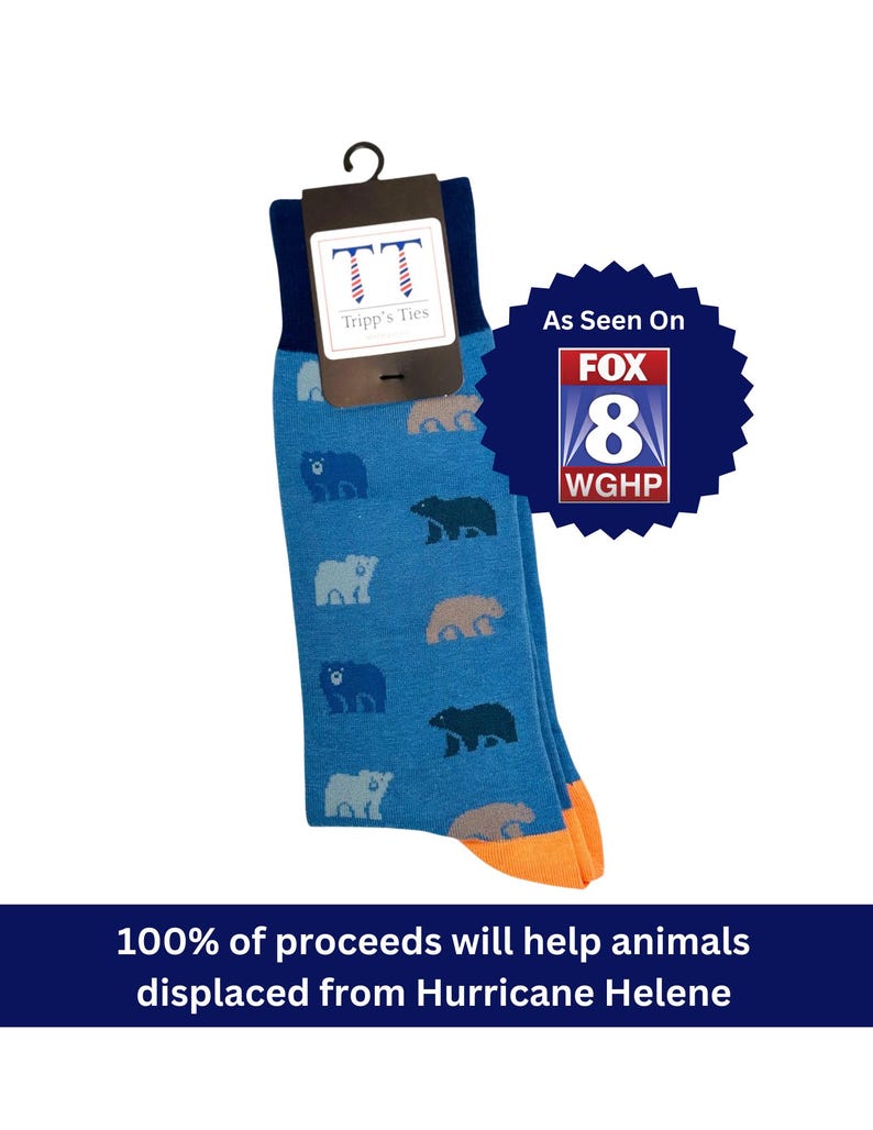 blue socks with orange toe and heel cap with bear motif in shades of blue, green and tan. Text says "100% of proceeds will help animals displaced from Hurricane Helene" and "As Seen on Fox 8 WGHP"