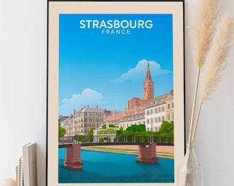 May include: A colorful illustration of Strasbourg, France, featuring a bridge over a canal, buildings, and the Strasbourg Cathedral. The text "STRASBOURG FRANCE" is at the top of the image.
