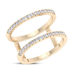 May include: A double-band ring with a gold-colored band and a row of small, clear gemstones set along the top of each band. The two bands are connected by vertical gold bars.
