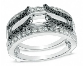 May include: A silver ring with a unique design. The ring features a row of small, clear stones and a row of black stones. The ring has a layered appearance, with multiple bands creating a three-dimensional effect.