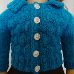 May include: A bright turquoise knitted cardigan featuring a textured basketweave pattern, a classic collar, and five white buttons down the front. The long-sleeved garment has ribbed cuffs and a ribbed hem, showcasing a consistent yarn knit construction.