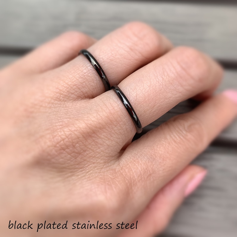 May include: Two thin black plated stainless steel rings worn on a finger.