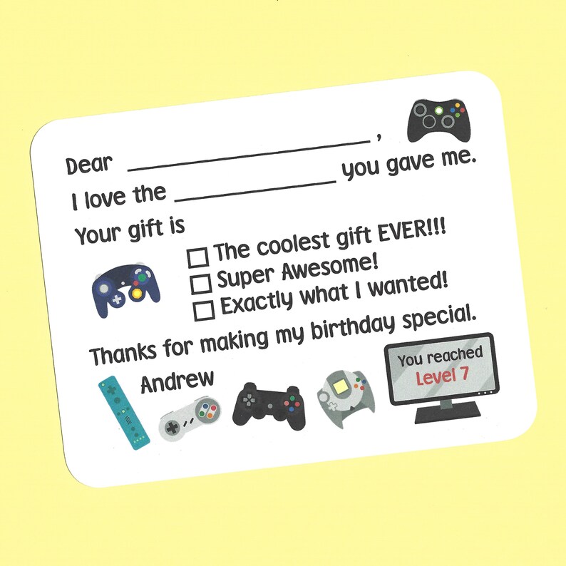 May include: A thank you card for a birthday gift, featuring a video game theme. The card has a blank space for the recipient's name and a check box to indicate how much the recipient liked the gift. The card also includes a variety of video game controllers and a screen displaying "You reached Level 7".