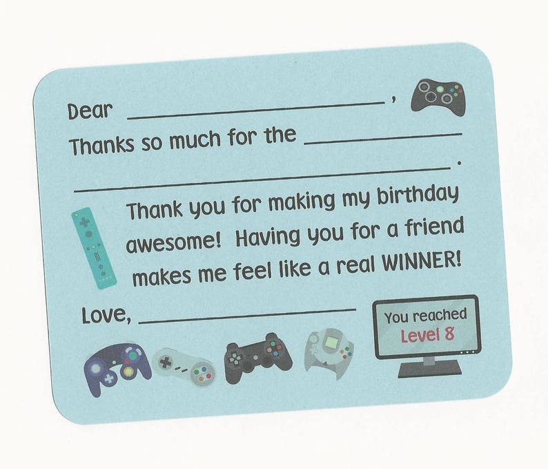 May include: A light blue thank you card with a video game theme. The card has a space to write "Dear" and "Love," and includes the text "Thanks so much for the..." and "Thank you for making my birthday awesome! Having you for a friend makes me feel like a real WINNER!" The card also features a variety of video game controllers and a screen that says "You reached Level 8."