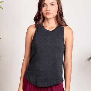 May include: A dark gray sleeveless tank top with a rounded hem. The tank top is made of a soft, comfortable fabric.