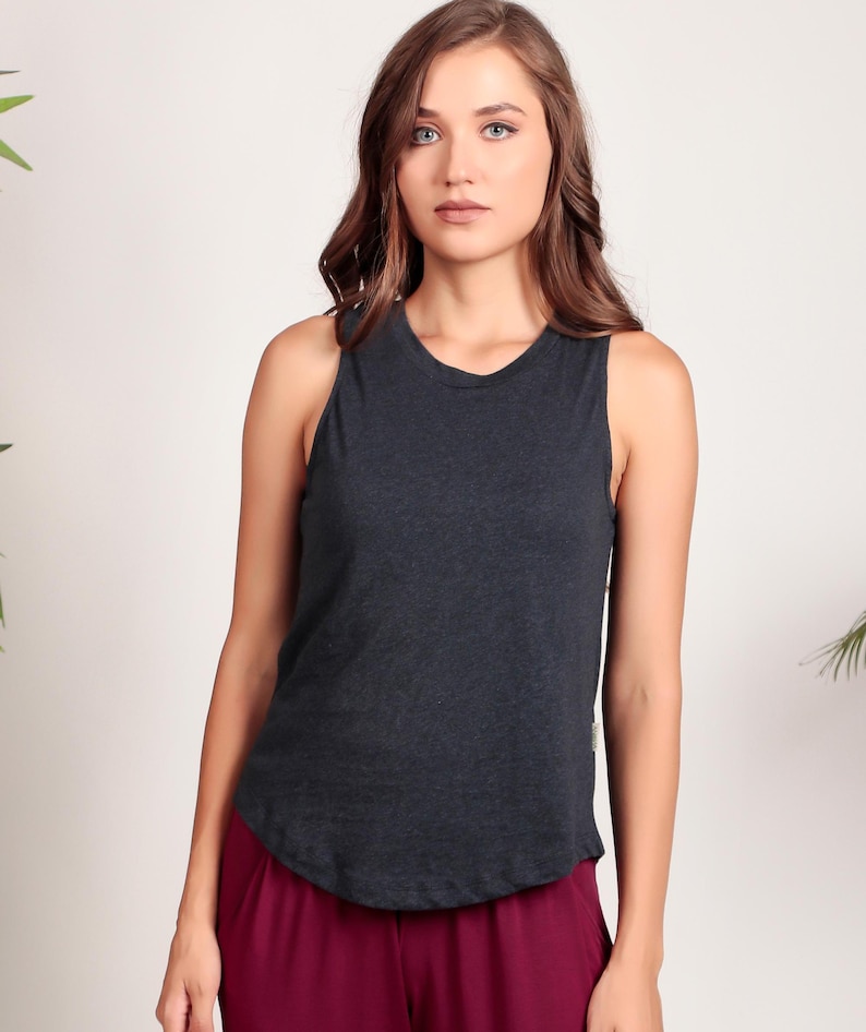 May include: A dark gray sleeveless tank top with a rounded hem. The tank top is made of a soft, comfortable fabric.