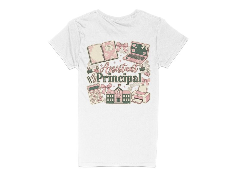 May include: White t-shirt with a colorful graphic design. The design includes a notebook, laptop, calculator, school building, and printer, with the words "Assistant Principal" in the center. Pink and green accents.