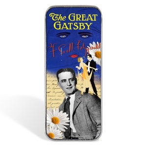 May include: A silver metal book match holder with a vintage design featuring a blue background with the text "The Great Gatsby" and a portrait of F. Scott Fitzgerald. The holder also features a couple dancing and a daisy.