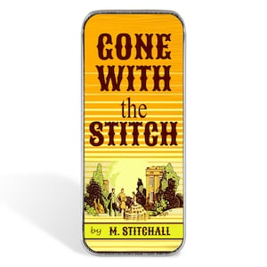 May include: A yellow and orange tin with the text "Gone With the Stitch" in brown letters. The text "by M. Stitchhall" is at the bottom of the tin. The tin has a picture of a house and three people in front of it.