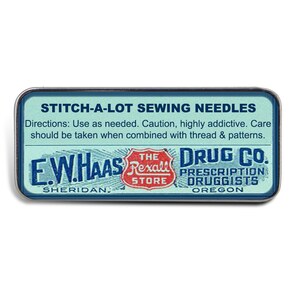 May include: A vintage-style metal tin with a blue background and white lettering. The tin reads "Stitch-A-Lot Sewing Needles" and features the logo for "E.W. Haas Rexall Drug Co. Prescription Druggists, Sheridan, Oregon".
