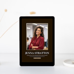 May include: A digital tablet displays a portrait of a woman with curly hair wearing a burgundy blouse. The text "JENNA STRATTON" is below the image, along with her credentials. The tablet is on a white surface with a vase and decorative sprigs.