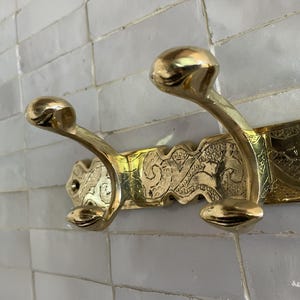 Brass Wall Hook,
Vintage Coat Hook,
Antique Brass Hanger,
Wall Mounted Hooks,
Rustic Home Décor,
Brass Entryway Hook,
Hat and Coat Hook,
Victorian Style Hook,
Towel Hook Bathroom,
Brass Hook,
Handcrafted Hook,
Decorative Wall Hook,