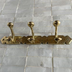 Brass Wall Hook,
Vintage Coat Hook,
Antique Brass Hanger,
Wall Mounted Hooks,
Rustic Home Décor,
Brass Entryway Hook,
Hat and Coat Hook,
Victorian Style Hook,
Towel Hook Bathroom,
Brass Hook,
Handcrafted Hook,
Decorative Wall Hook,