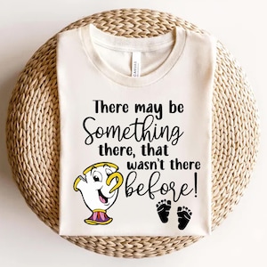 May include: A white t-shirt with a black graphic that says "There may be something there, that wasn't there before!" with a cartoon image of a teacup and two black footprints.