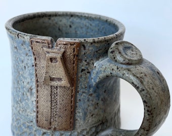 Mug with a zipper in rustic speckled blue