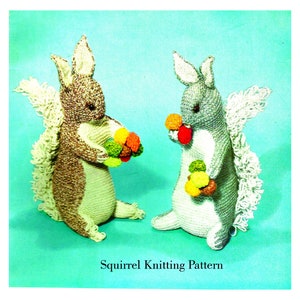 May include: Two knitted squirrel toys holding colourful balls. The squirrels are brown and grey with white accents. The text "Squirrel Knitting Pattern" is at the bottom of the image.
