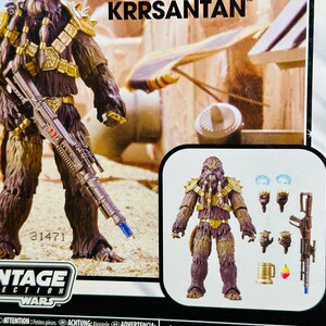 Puede incluir: Una figura de acci&oacute;n de la colecci&oacute;n Vintage de Star Wars de Krrsantan, un cazarrecompensas Wookiee. La figura es marr&oacute;n y morada con armadura dorada y un rifle bl&aacute;ster. El embalaje incluye el texto "KRRSANTAN" y "STAR WARS VINTAGE COLLECTION".