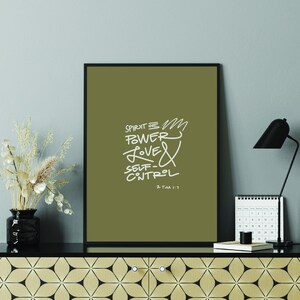 May include: A framed print with a green background and white text that reads "Spirit of power, love & self-control 2 Tim 1:7".