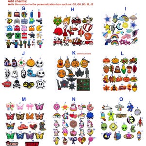 May include: A collection of colorful shoe charms organized into labeled groups G through O. Each charm features unique designs including video game icons, sports themes, celestial shapes, holiday motifs, butterflies, unicorns, and space elements.