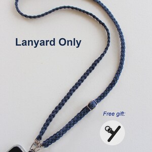 May include: A dark blue braided cord lanyard featuring a silver-toned metal adjustable slider and two lobster claw clasps attached to a phone case. The text Lanyard Only and Free gift are printed on the image next to a small icon.
