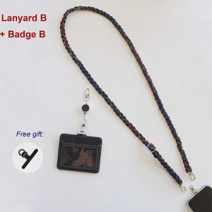 May include: A braided black lanyard with subtle red and yellow accents, featuring a metal adjuster and clips. Includes a black rectangular badge holder with a clear window, a retractable reel, and a small black strap accessory labeled Free gift.