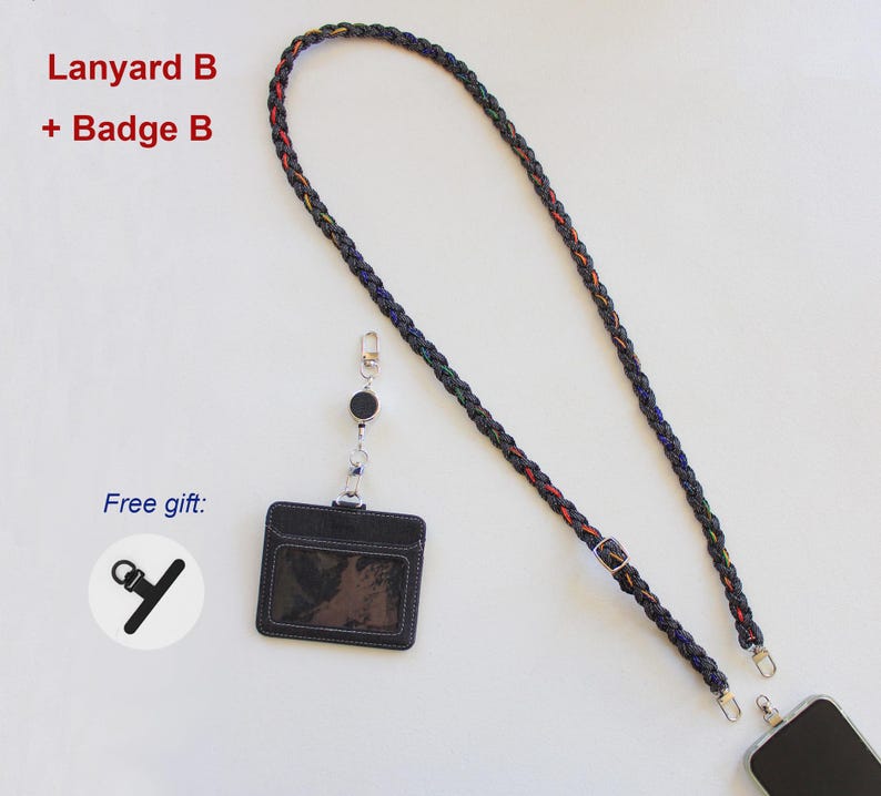 May include: A braided black lanyard with subtle red and yellow accents, featuring a metal adjuster and clips. Includes a black rectangular badge holder with a clear window, a retractable reel, and a small black strap accessory labeled Free gift.