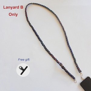 May include: A braided dark-colored lanyard with subtle multicolored accents, featuring a metal adjustment buckle and a silver-toned lobster clasp attached to a smartphone. The text Lanyard B Only and Free gift are visible.