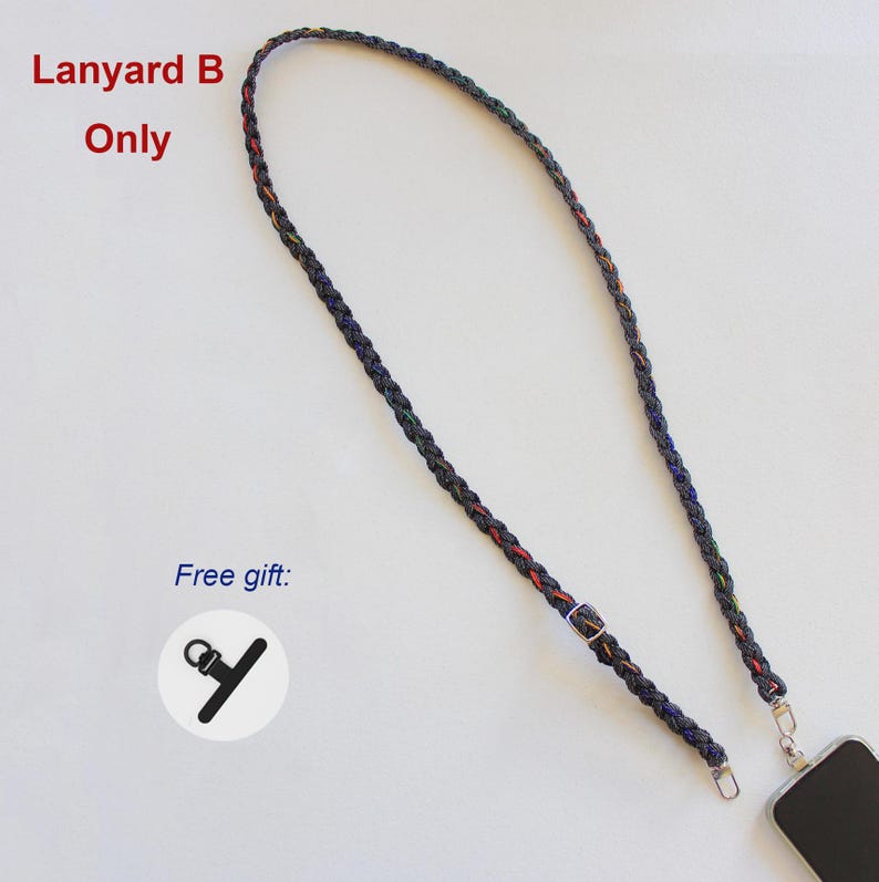 May include: A braided dark-colored lanyard with subtle multicolored accents, featuring a metal adjustment buckle and a silver-toned lobster clasp attached to a smartphone. The text Lanyard B Only and Free gift are visible.