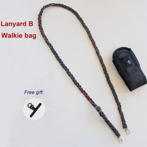 May include: A braided black lanyard with thin red and yellow accents, featuring a metal adjustment buckle and two silver-tone clips. Includes a black fabric walkie-talkie pouch with a snap button and a small black plastic accessory labeled Lanyard B + Walkie bag.