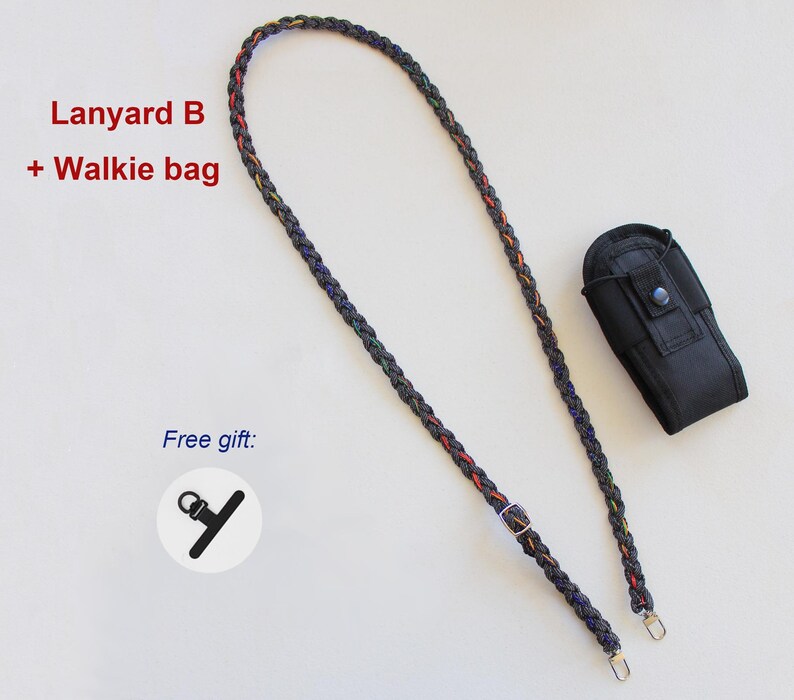 May include: A braided black lanyard with thin red and yellow accents, featuring a metal adjustment buckle and two silver-tone clips. Includes a black fabric walkie-talkie pouch with a snap button and a small black plastic accessory labeled Lanyard B + Walkie bag.