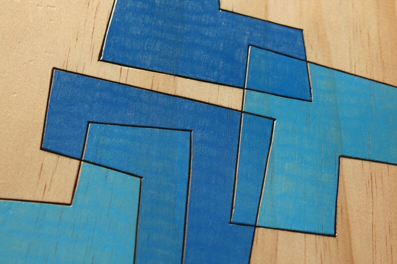 May include: Abstract geometric design painted on a wooden surface. The design features overlapping shapes in shades of blue.