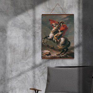 May include: A painting of a man on horseback, wearing a red cloak and a bicorne hat. The horse is white with a black mane and tail. The painting is set against a mountainous backdrop.
