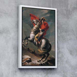 May include: A painting of a man on horseback, wearing a red cloak and a bicorne hat. The horse is white with a black mane and tail. The background is a mountainous landscape.