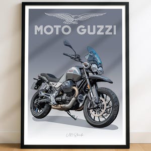 May include: Framed print featuring a Moto Guzzi V85 Strada motorcycle illustration. The artwork showcases a detailed depiction of the bike in shades of gray, black, and silver, with a blue windscreen. The Moto Guzzi logo and text are displayed above the motorcycle.