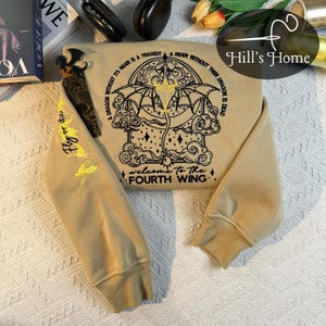 May include: A beige sweatshirt with a black embroidered design of a dragon with the text "A dragon without its rider is a tragedy. A rider without their dragon is dead. Welcome to the Fourth Wing."