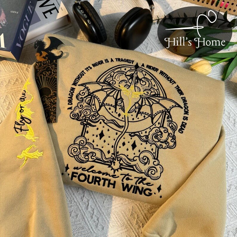 May include: A tan sweatshirt with a black embroidered design of a dragon with the text "A dragon without its rider is a tragedy. A rider without their dragon is dead. Welcome to the fourth wing."