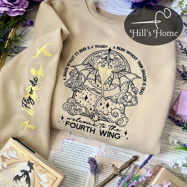 May include: A beige sweatshirt with black embroidery of a dragon and the text "A dragon without its rider is a tragedy. A rider without their dragon is dead. Welcome to the Fourth Wing."
