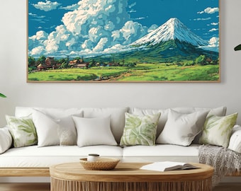 May include: A framed landscape art print depicts a mountain with a snow-capped peak, lush green foothills, and a village under a bright blue sky with fluffy white clouds. The artwork is displayed above a white sofa and wooden coffee table.