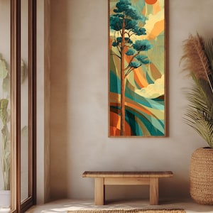 May include: A framed vertical art print depicting a stylized tree with teal foliage and a brown trunk against a backdrop of orange, yellow, and teal abstract shapes. A red sun is in the upper right corner. The artwork is displayed above a wooden bench and a woven rug.