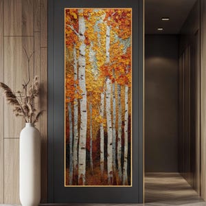 May include: Vertical rectangular painting of a forest scene. White birch trees with orange and yellow leaves fill the frame. The artwork is in a gold frame and hangs on a dark gray wall. A tall white vase with dried plants is to the left.