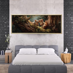 May include: A framed artwork showing two squirrels in a tree. The squirrels, with brown fur and bushy tails, are set against green moss and a detailed tree trunk. The artwork is framed in a gold-coloured frame, adding a touch of elegance.