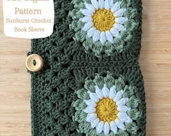 May include: A dark green crochet book sleeve with two daisy-shaped appliqués, each with white petals and a yellow centre. The text "PDF Digital Pattern Sunburst Crochet Book Sleeve" is visible. A wooden button fastens the sleeve closed.