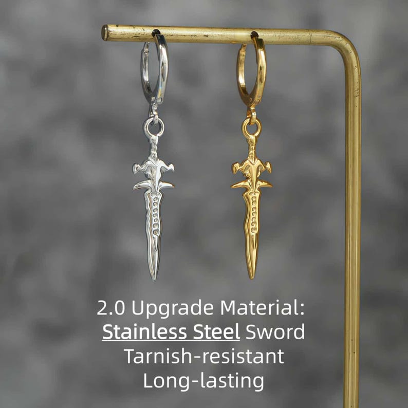 May include: Two hoop earrings featuring sword-shaped pendants, one in silver-tone and one in gold-tone metal. The text 2.0 Upgrade Material: Stainless Steel Sword Tarnish-resistant Long-lasting is printed below the earrings.