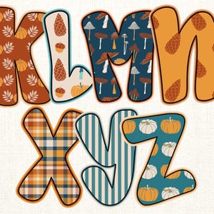 May include: Colorful letters K, L, M, X, Y, and Z with autumn-themed patterns. The letters feature pumpkins, pinecones, mushrooms, and plaid designs in shades of orange, teal, and brown. The letters are outlined in a dark brown.