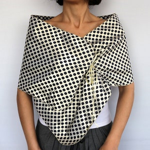 Reversible gold polka dot taffeta wrap worn over the shoulders for weddings and special occasions