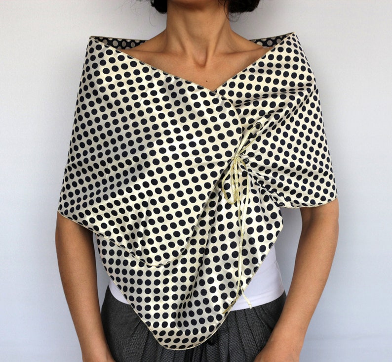 Reversible gold polka dot taffeta wrap worn over the shoulders for weddings and special occasions