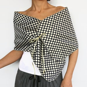 Navy polka dot shawl with gold reverse side styled as an elegant evening dress topper